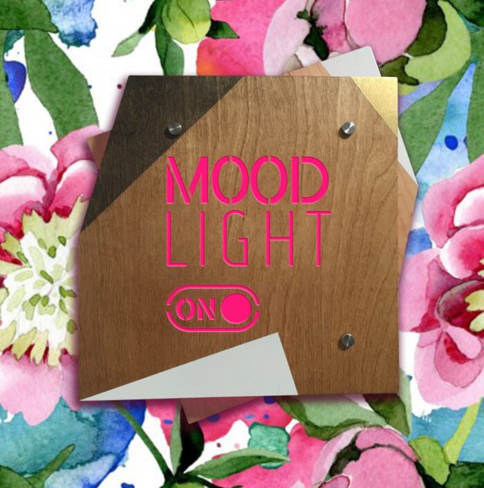 MOOD LIGHT ON - REBELlamps.com LED sign on a flowery wallpaper with a pink light on